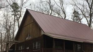 A large wooden cabin with a metal roof, a balcony, and a staircase leading to the upper level. - Cozy Quiet Cabin @ Lake Anna (Mineral)