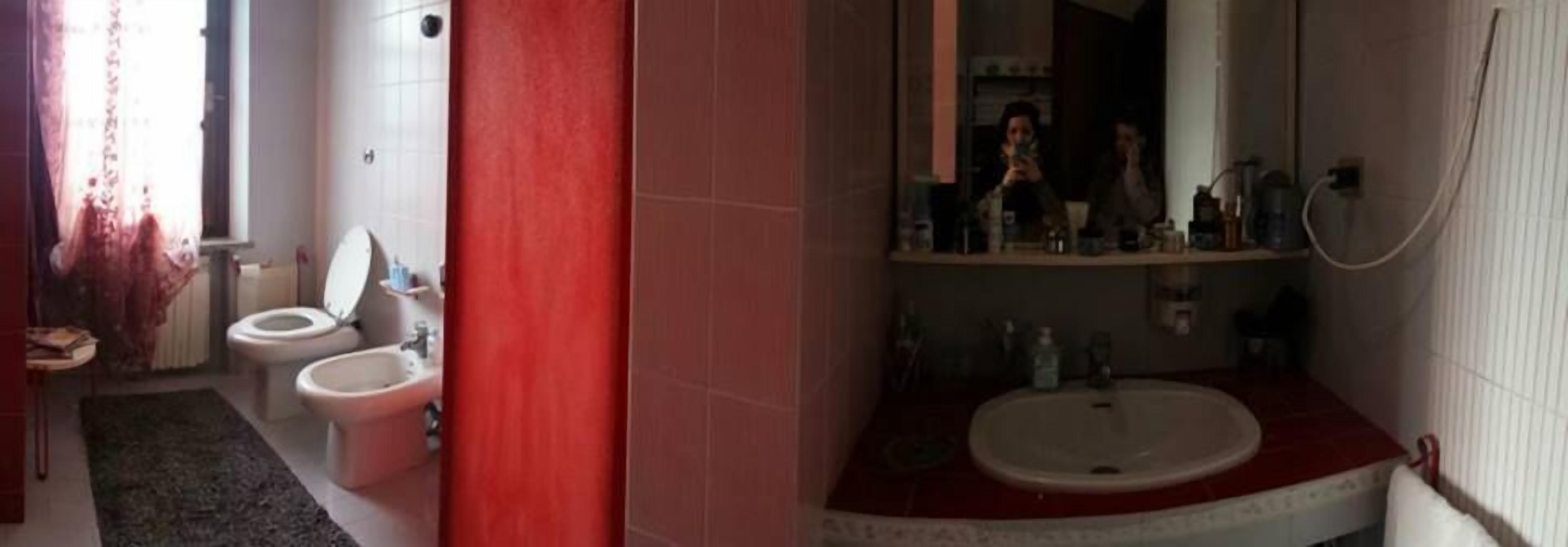 A bathroom with a toilet, bidet, and sink.