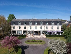 A large, two-story building with a symmetrical facade, multiple windows, and a central entrance with a canopy. - Le Pré Saint Germain (Louviers)