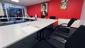 A conference room with a long table, chairs, and a painting on the wall. - Le Pré Saint Germain (Louviers)