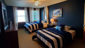 A hotel room with two beds, a desk, a lamp, and a painting on the wall. - Wine trail lakefront luxury stay on Seneca Lake with all the views and amenities (Geneva)