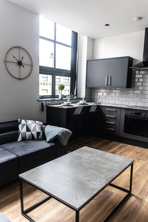 Elite Apartment | Living area | 55-inch Smart TV with digital channels, TV, fireplace - Spire Accommodations Ltd. (Bradford)