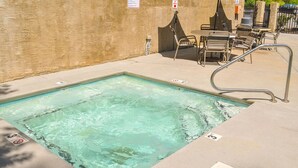 A rectangular pool with a metal ladder and a seating area with chairs and tables. - Beaver's Treehouse - Private Pool and Sauna! (Pigeon Forge)