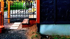 A wooden entrance gate with a sign reading "Snowy River Entrance" and a wooden structure with string lights. - Snowy River @ big Powderhorn (Bessemer)
