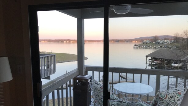 A balcony with a view of a lake, a dock, and a small building. - Amazing Views and Two Kayaks Ready to Use! (Moneta)