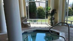 An indoor swimming pool with a metal ladder, surrounded by columns and a glass enclosure. - Amazing Views and Two Kayaks Ready to Use! (Moneta)