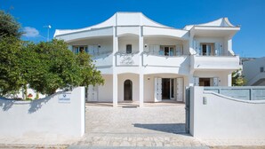 A white building with multiple balconies and a sign that reads "Villa Michele".