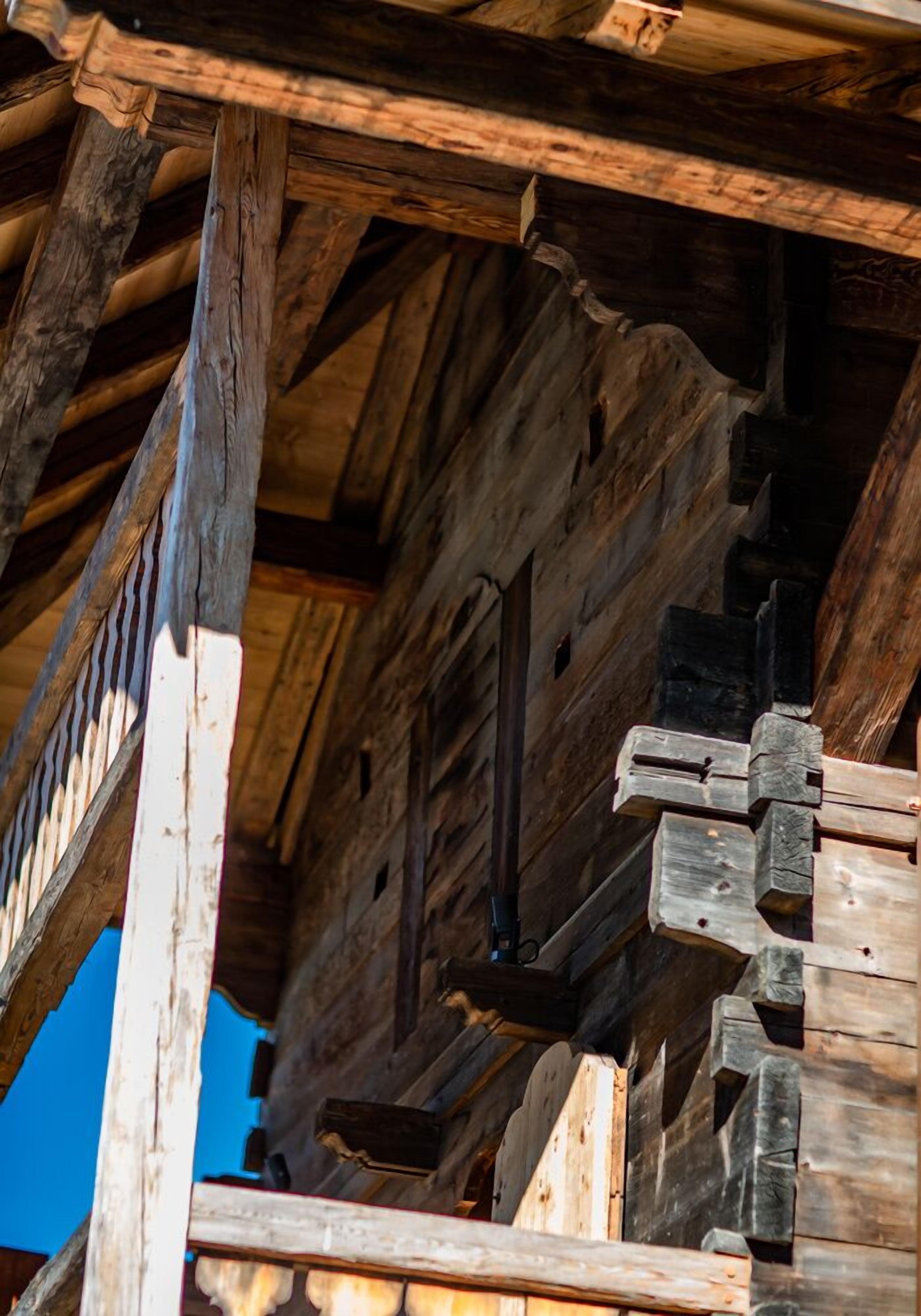 A wooden structure with a sloped roof and exposed beams.