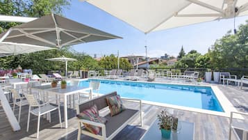 Seasonal outdoor pool, open 9:00 AM to 7:00 PM, pool umbrellas