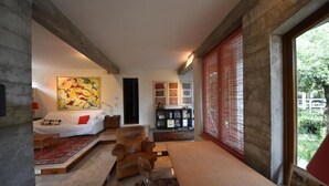Un salon moderne avec un canapé, une table basse et un tableau accroché au mur.