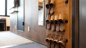 A wall-mounted shoe rack with multiple pairs of shoes.