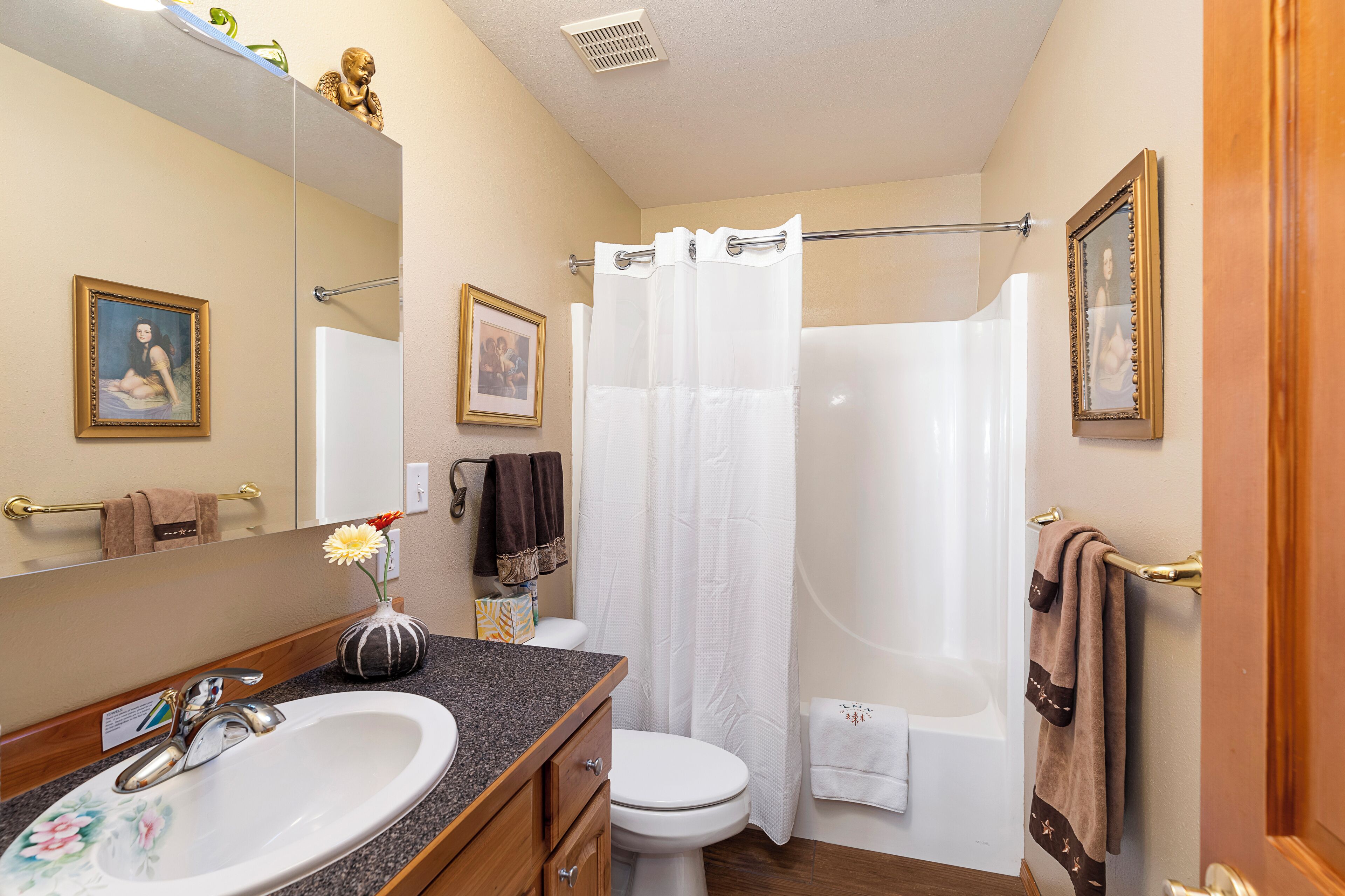 A bathroom with a sink, toilet, shower, and bathtub.