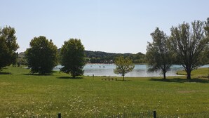 A grassy park with trees and a lake. - Gîte du Silence - Stylish gîte in beautiful French countryside (Coulx)