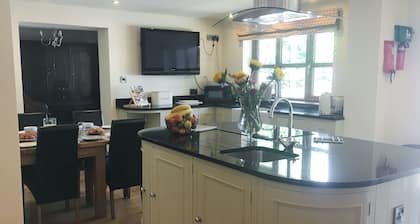 Large detached property with a patio, hot tub and enclosed garden.