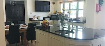 Large detached property with a patio, hot tub and enclosed garden.