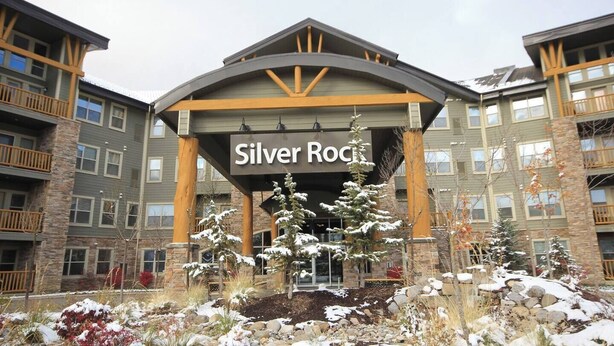 A multi-story building with a sign reading "Silver Rock". - Time for a Getaway? Pool and A/C (Fernie)