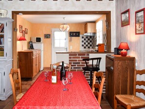 Enjoy casual dining and cooking in this well-equipped kitchen with a modern stove, microwave, and coffee machine.
