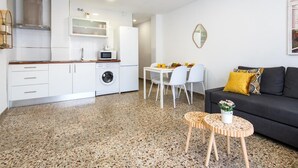A compact living space with a kitchenette, dining area, and seating area. - STREET ART FANTASY 1 APARTMENT (MALAGA)
