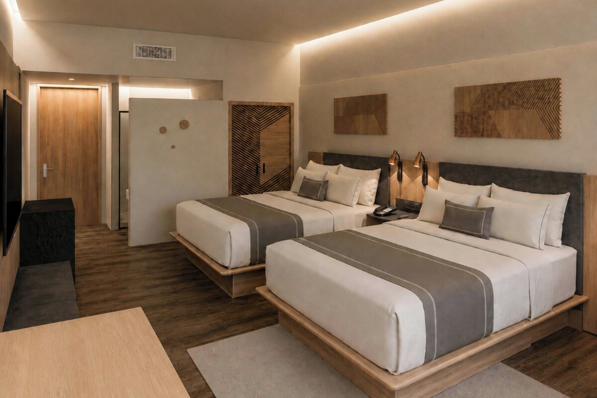 Una habitación de hotel moderna con dos camas, un escritorio y un armario.
