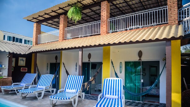 A poolside area with lounge chairs and a hammock.