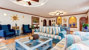 A spacious living room with a sofa set, armchairs, and a coffee table. - Residencia Jardin Real (Cuernavaca)