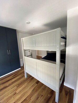 Sleep comfortably in this cozy room with a bunk bed featuring a lower and upper sleeping area.