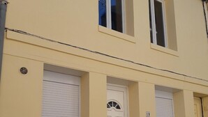 A two-story building with a yellow facade, white doors, and shutters. - Le Cézard de Fleury (Le Tréport)