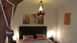 A bedroom with a bed, a hanging light fixture, and three paintings on the wall. - Le Cézard de Fleury (Le Tréport)