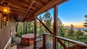 A wooden deck with a hot tub, chairs, and a staircase leading to a scenic view. - Mv50 Grand Lodge Lake Tahoe With Game Room Hot (Stateline)