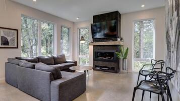 Télévision, cheminée, lecteur de DVD, baby-foot