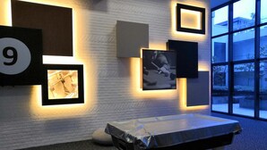 A modern room with a pool table, framed pictures on the wall, and a large window offering a view of the outside. - USJ One Premium Suites at Subang Sunway USJ (Subang Jaya)