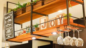 A wooden shelf with the word "JOY" and a sign that says "Welcome Home Everything is Air".