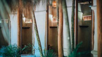 Escape to a serene tropical oasis with a thatched roof and natural elements surrounding you.