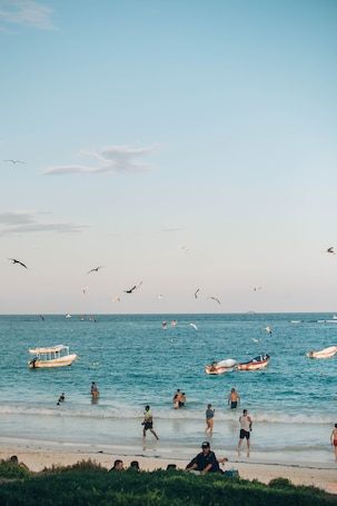 On the beach, white sand, beach cabanas, beach towels