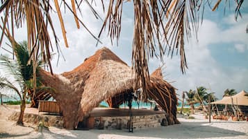 On the beach, white sand, beach cabanas, beach towels