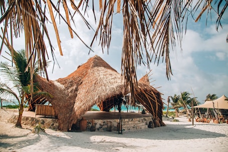 On the beach, white sand, beach cabanas, beach towels