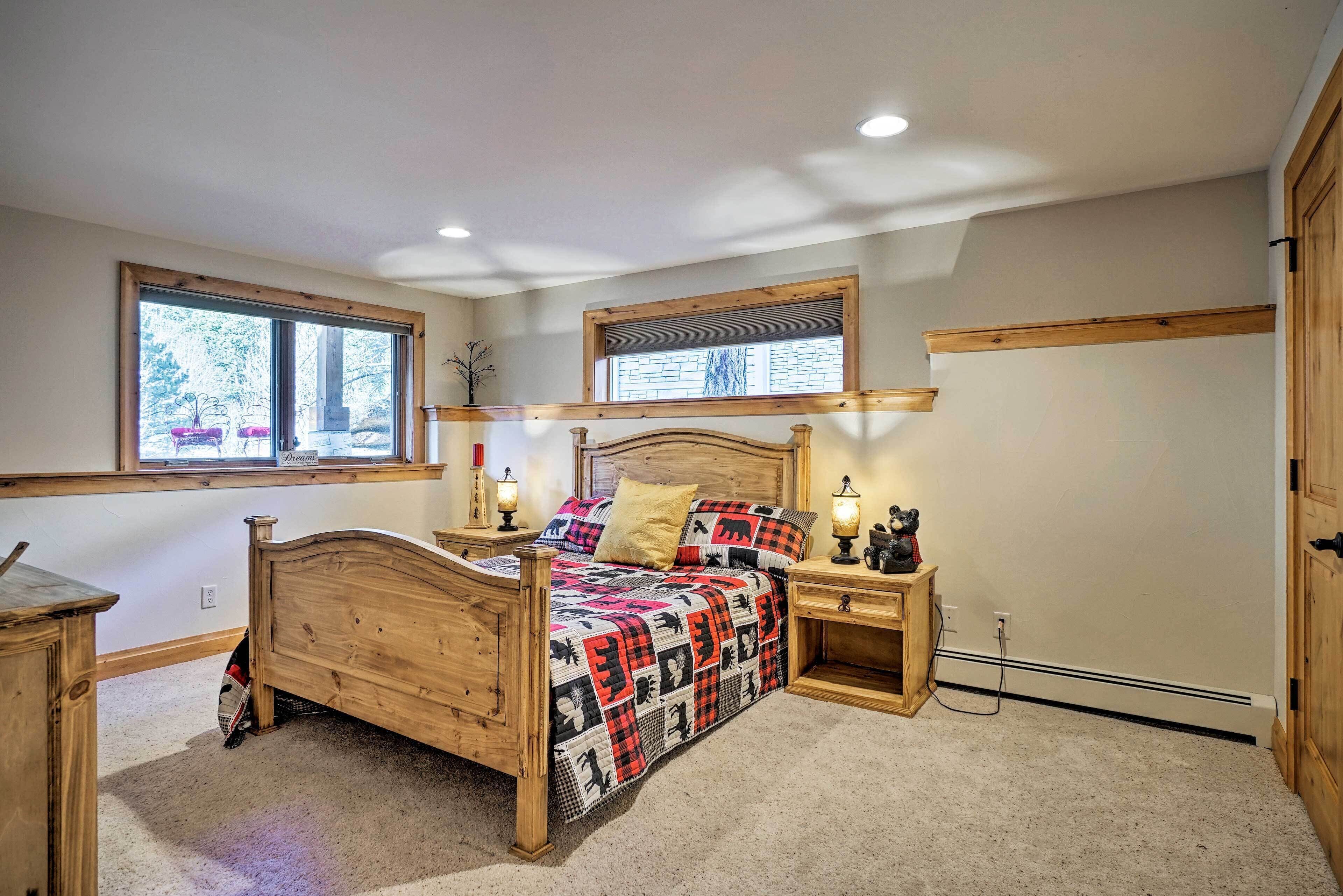 A bedroom with a wooden bed, two bedside tables, a window, and a built-in shelf.