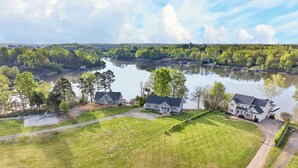 A residential area with houses, a lake, and a forested landscape. - Lake Anna Waterfront - Sleeps 21 - Dock for 3 Boats (Orange)
