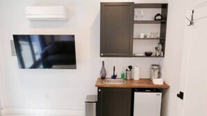 A compact kitchen with a built-in dishwasher, a small sink, and a microwave.