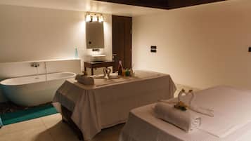 Relax in a serene space with a bathtub, vanity area, and a comfortable bed.