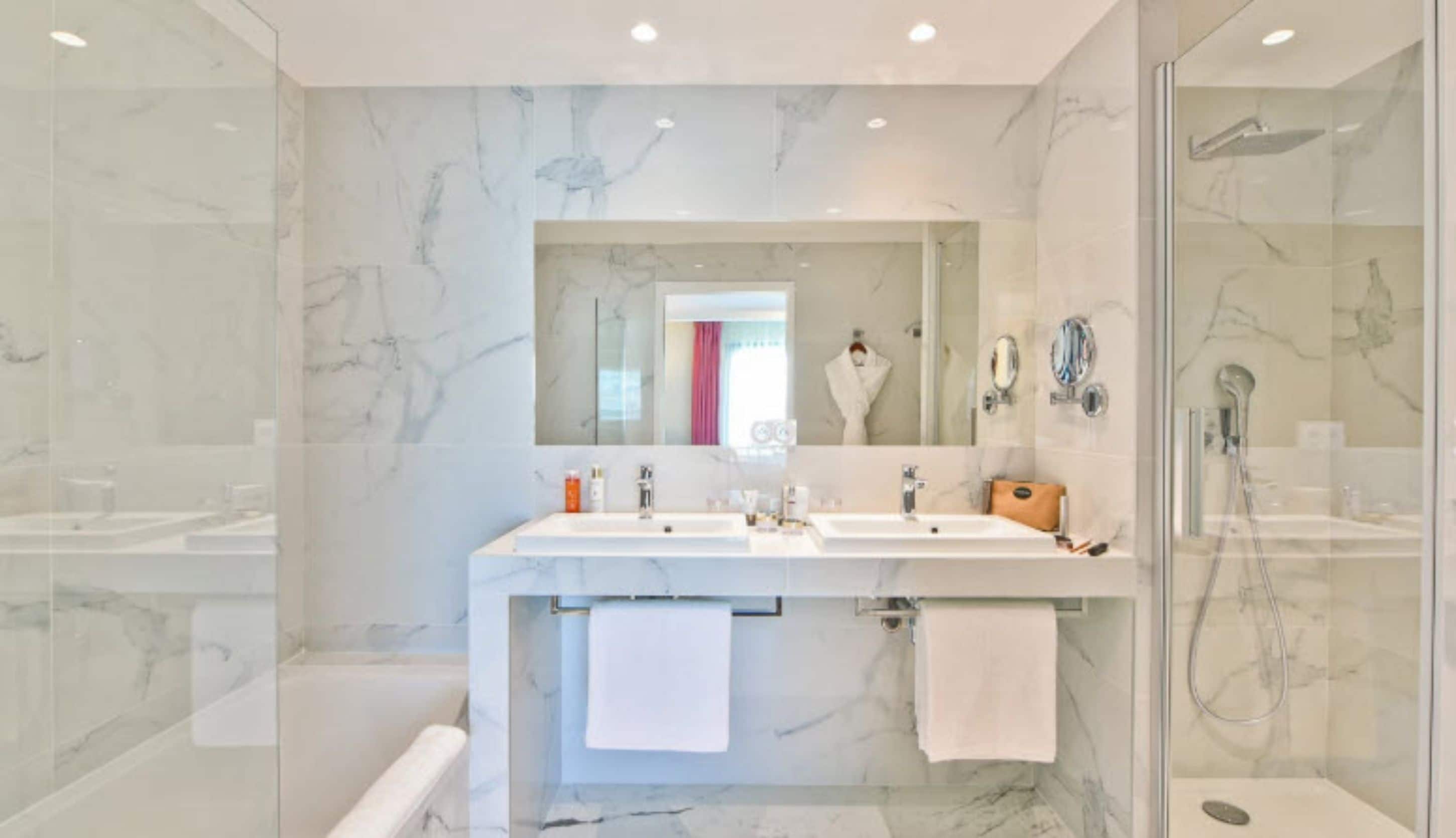 junior suite, balcony, city view | bathroom | designer toiletries, hair dryer, bathrobes, slippers