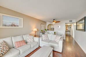A living room with two sofas, a coffee table, a ceiling fan, and a dining area with a table and chairs. - Walk to Family Kingdom, Ocean: Myrtle Beach Condo! (Myrtle Beach)