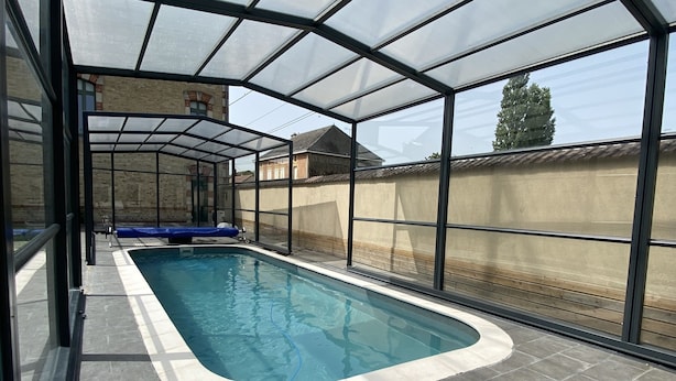 A covered swimming pool with a clear view of the surrounding area.