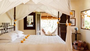 A bed with a canopy, a hammock, and a small table with a vase. - Heavenly 3B/R Villa, Rice Field views & 10 min to popular Bali areas (seminyak)
