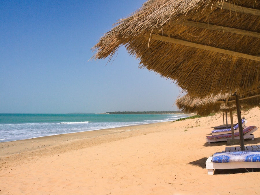 On the beach, white sand, sun loungers, beach umbrellas