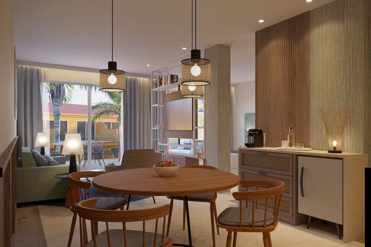 Cozinha moderna com mesa redonda de madeira, quatro cadeiras, luminárias pendentes e estante embutida.
