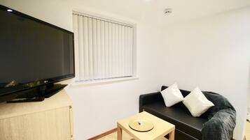 Apartment, 1 Bedroom | Living room | Flat-screen TV