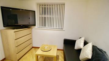 Apartment, 1 Bedroom | Living room | Flat-screen TV