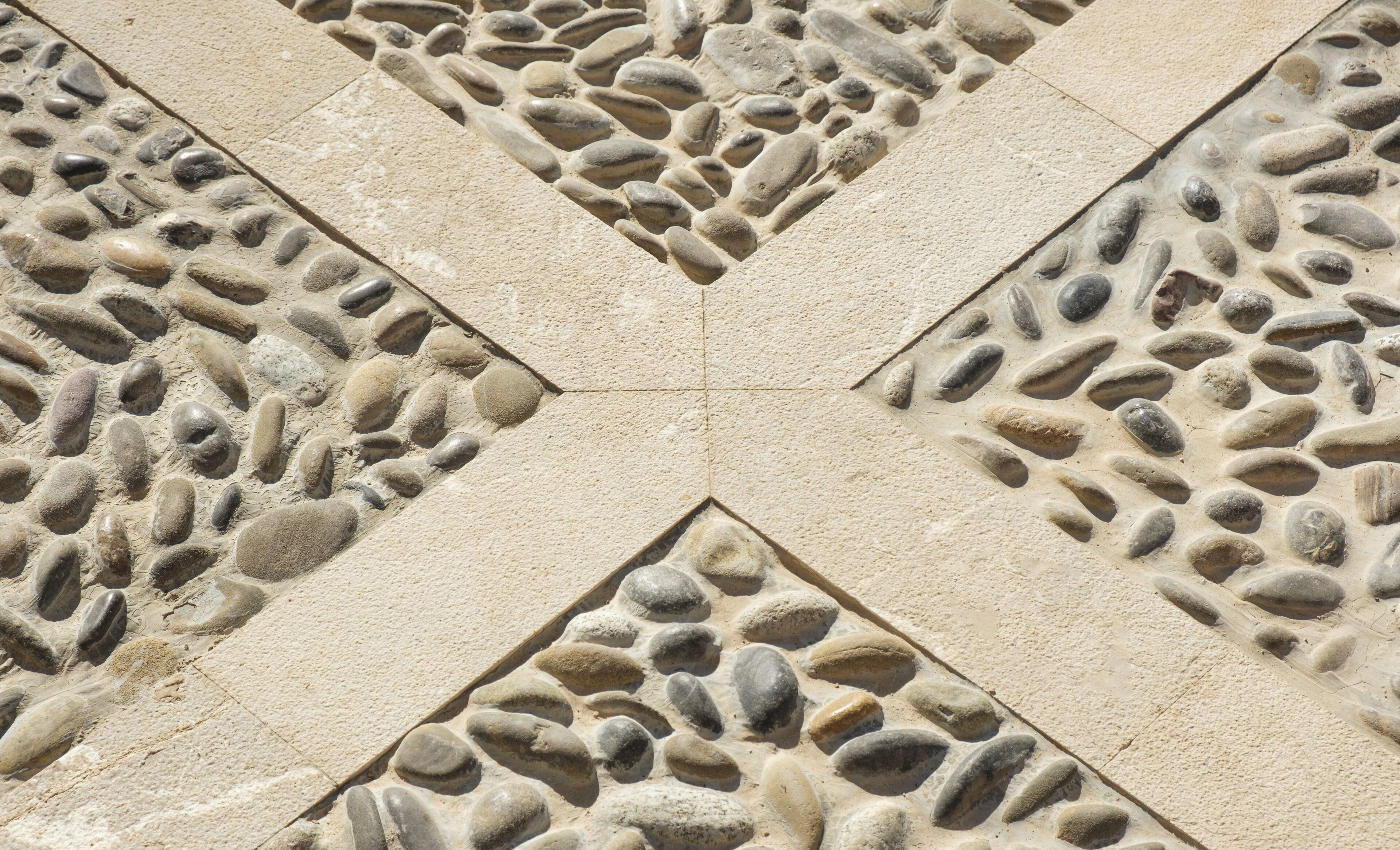 A geometric pattern of stone tiles with a central diamond shape.