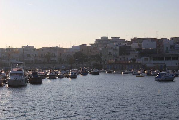 A marina with boats docked, surrounded by buildings.